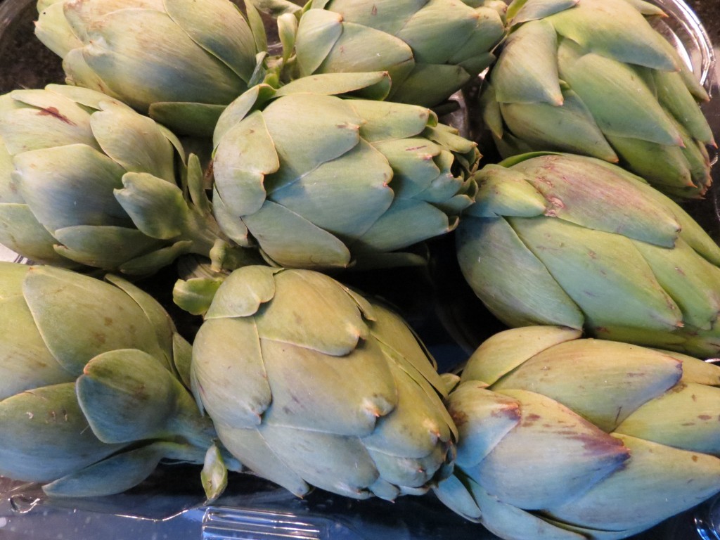 Whole baby artichokes, ready to be trimmed.  You will discard all of those tough exterior leaves prior to cooking them.
