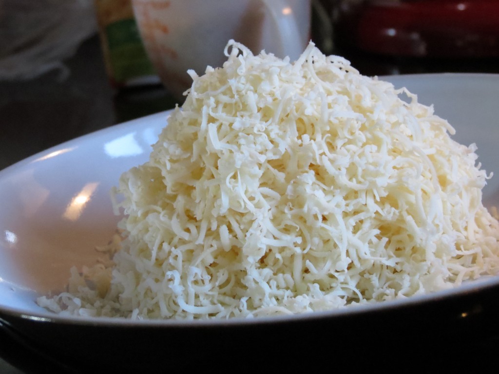 A mountain of freshly grated Swiss cheese.  