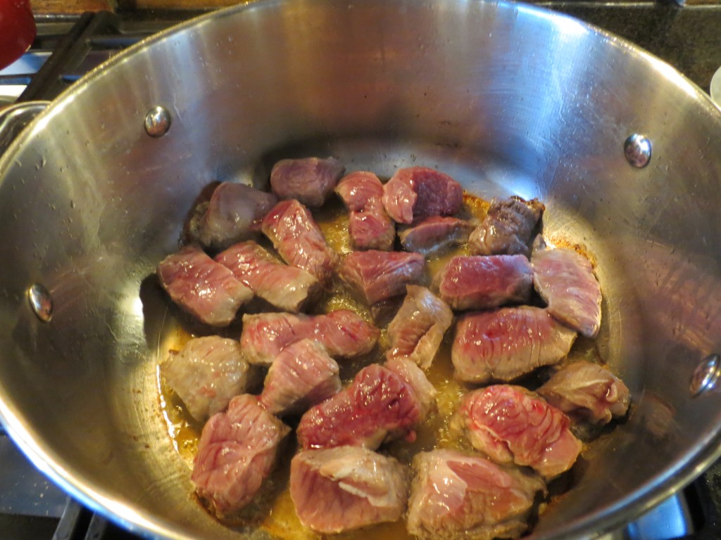 The lamb sizzles in the pan, ready for a bronzing session before we begin the sauce for the stew.